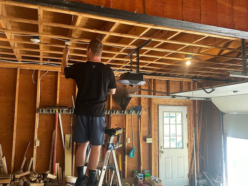 Technician performing emergency garage door repair